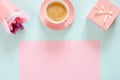 Bouquet of stabilized flowers, cup of coffee and gift box on blue and pink background Royalty Free Stock Photo