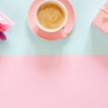 Bouquet of stabilized flowers, cup of coffee and gift box on blue and pink background Royalty Free Stock Photo