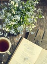 Bouquet of summer blue flowers, cup of tea and vintage books Royalty Free Stock Photo