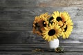 Bouquet of sunflowers in vase on wooden background with copy space. Autumn flowers. Royalty Free Stock Photo