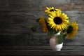 Bouquet of sunflowers in vase. Yellow flower arrangement on wooden background with copy space. Autumn flowers. Fall season Royalty Free Stock Photo