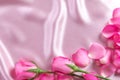 a bouquet sweet pink roses petal on soft pink silk fabric , romance and love card concept Royalty Free Stock Photo