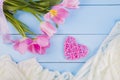 Bouquet of tender pink tulips with heart and fabric on blue wood Royalty Free Stock Photo