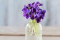 Bouquet of tiny violets viola odorata on wooden table