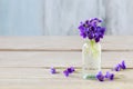 Bouquet of tiny violets viola odorata on wooden table