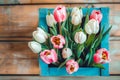 bouquet of tulips in box on a wooden background with a place for the inscription, top view Royalty Free Stock Photo