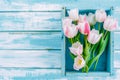 bouquet of tulips in box on a wooden background with a place for the inscription, top view Royalty Free Stock Photo