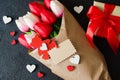 Bouquet of tulips and gift box on dark background Royalty Free Stock Photo