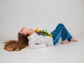 a bouquet of tulips and irises lies on a blonde girl in a white shirt and blue jeans on a white background. March 8. bouquet of fl Royalty Free Stock Photo