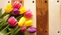Bouquet of tulips over plates on wooden table Royalty Free Stock Photo