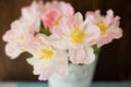 Bouquet of tulips with pink and white petals in white metal vase. Royalty Free Stock Photo