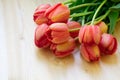 Bouquet of tulips at right corner on white wooden background. Top view, frame, border, copy space. Greeting card for womans da Royalty Free Stock Photo