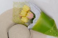 Straw hat and bouquet of yellow tulips