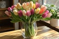 Bouquet of vibrant tulips adds a touch of spring to a sunlit interior Royalty Free Stock Photo