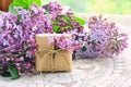 Bouquet of violet lilac, small gift box Royalty Free Stock Photo