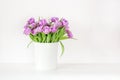 Bouquet of violet tulips in bucket. Fresh spring easter flower. Woman& x27;s day greeting card. White background , copy space