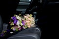 Bouquet of wedding flowers on the car seat Royalty Free Stock Photo