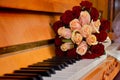 A bouquet of wedding flowers on the piano keys.