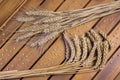 Bouquet of wheat and rye on a wooden table.