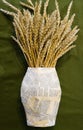 bouquet of wheat spikes in a paper vase. handmade still life. Royalty Free Stock Photo