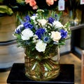 Bouquet with white and blue flowers in a glass vase Royalty Free Stock Photo