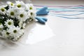 Bouquet of white chrysanthemums with tapes and two blue hearts on white background Royalty Free Stock Photo