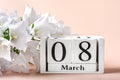 Bouquet of white flowers, calendar with date 08 march on pink background Holiday greeting card International womens day Royalty Free Stock Photo