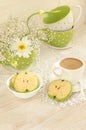 Bouquet of white flowers, cup coffee with milk and apple shaped cookies Royalty Free Stock Photo