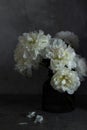 Bouquet white flowers peonies vase dark mood