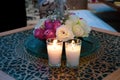 Bouquet of white flowers in a vase, candles on vintage copper tray, wedding home decor on a table Royalty Free Stock Photo