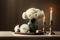 Bouquet of white flowers in a vase, candles on vintage copper tray, wedding home decor on a table Royalty Free Stock Photo