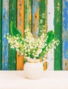 A bouquet of white fragrant forest flowers of lilies of the valley in a white jug Royalty Free Stock Photo