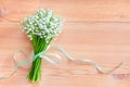 Bouquet of white lily of the valley flowers on a wooden background Royalty Free Stock Photo