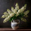A bouquet of white lush lilacs in a ceramic vase on a table Royalty Free Stock Photo