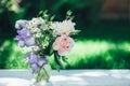 Bouquet of white peonies, chamomiles and iris flowers in glass vase. Summer background. Tinted photo Royalty Free Stock Photo