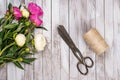 Bouquet of white and pink peonies flowers, twine and vintage scissors on white painted wooden planks.Top view. Royalty Free Stock Photo