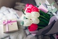 Bouquet of white and pink tulips with gift box at home. Spring flowers. Women`s day. Present for Mother`s day
