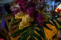 Bouquet of white and purple lilac on a wooden table in cafe Royalty Free Stock Photo