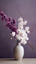 Bouquet of white and purple orchids in a vase on a dark background. Royalty Free Stock Photo