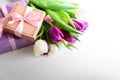 Bouquet of white and purple tulips and gift box on white wooden background. Top view. Flat lay. Copy space. Valentines day, Royalty Free Stock Photo