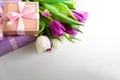 Bouquet of white and purple tulips and gift box on white wooden background. Top view. Flat lay. Copy space. Valentines day, Royalty Free Stock Photo