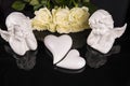 A bouquet of white roses, angels of love and porcelain hearts, Valentine`s Day Royalty Free Stock Photo