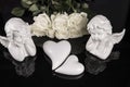 A bouquet of white roses, angels of love and porcelain hearts, Valentine`s Day Royalty Free Stock Photo