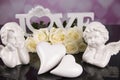 A bouquet of white roses, angels of love and porcelain hearts, Valentine`s Day Royalty Free Stock Photo