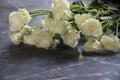 Bouquet of white roses on a background of black marble