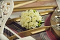 Bouquet of white roses for the bride on the piano