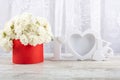 Bouquet of white roses in a red box and a white photo frame close-up. Royalty Free Stock Photo