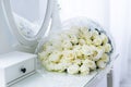 Bouquet of white roses reflected in the mirror. Bride`s bouquet