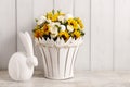 Bouquet of white roses and sunflowers and ceramic rabbit