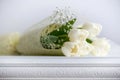 Bouquet of white tulips on an antique white furniture